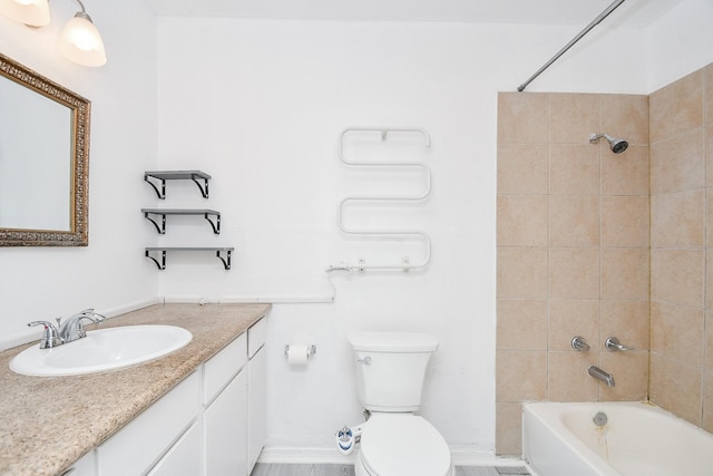 full bathroom with vanity, toilet, and tiled shower / bath