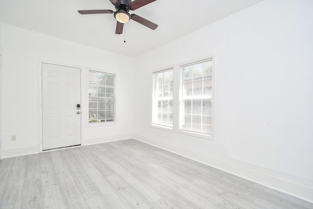 empty room featuring light wood-type flooring and ceiling fan