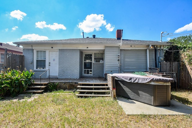 view of front of house with a swimming pool side deck and a front lawn