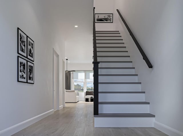 stairway featuring wood-type flooring