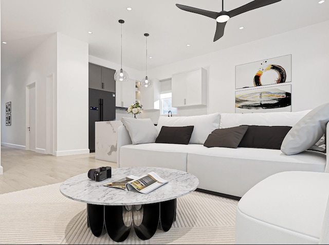 living room featuring light wood-type flooring and ceiling fan