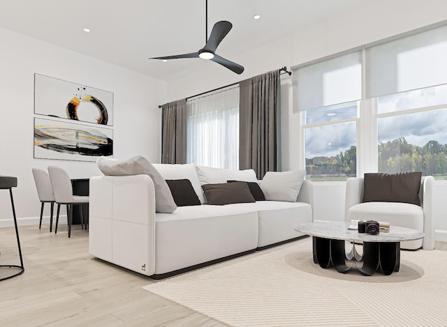 living room with light wood-type flooring and ceiling fan