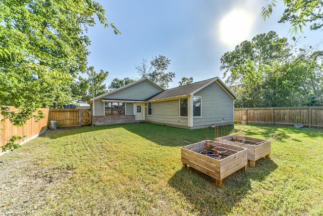 rear view of house with a yard