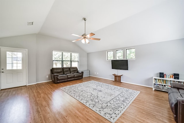 living room featuring hardwood / wood-style floors, ceiling fan, a wealth of natural light, and vaulted ceiling