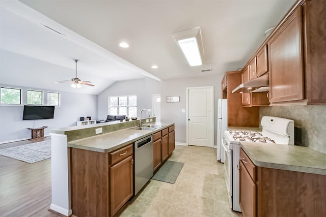 kitchen with decorative backsplash, white appliances, ceiling fan, sink, and lofted ceiling