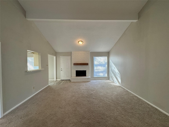 unfurnished living room featuring carpet flooring, lofted ceiling, and a brick fireplace