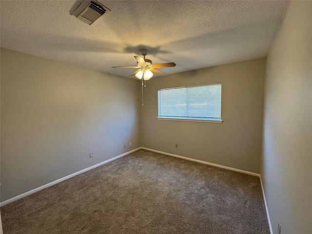 carpeted spare room with ceiling fan and a textured ceiling