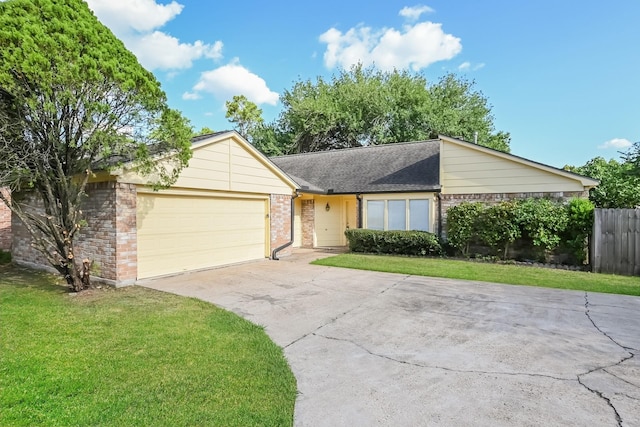 view of front of property with driveway, a garage, a front yard, and brick siding