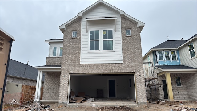 traditional home with a garage, brick siding, and fence