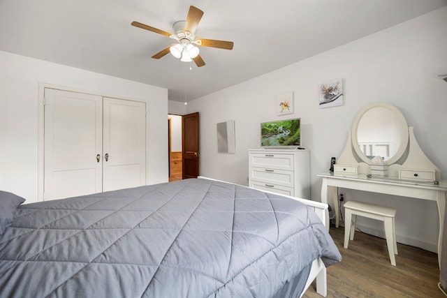 bedroom with ceiling fan, a closet, and wood-type flooring