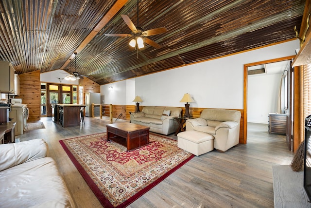 living room featuring hardwood / wood-style floors, lofted ceiling with beams, and ceiling fan