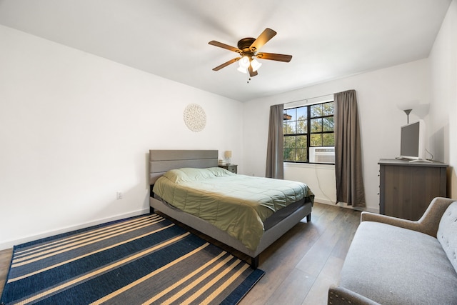 bedroom featuring ceiling fan and dark hardwood / wood-style floors