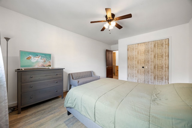 bedroom with light hardwood / wood-style flooring and ceiling fan