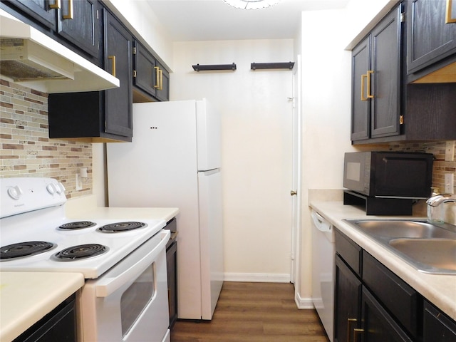 kitchen with tasteful backsplash, white appliances, sink, and dark wood-type flooring