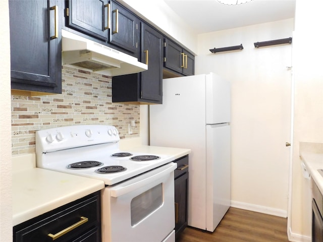 kitchen featuring backsplash, white appliances, and dark wood-type flooring