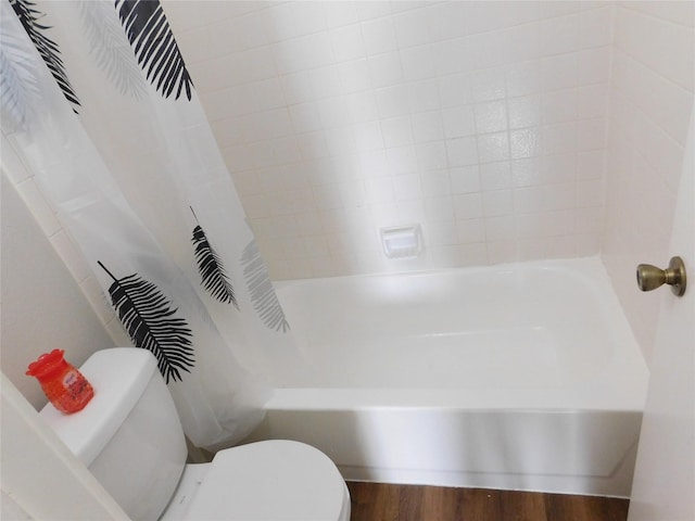 bathroom with shower / bath combo, toilet, and wood-type flooring