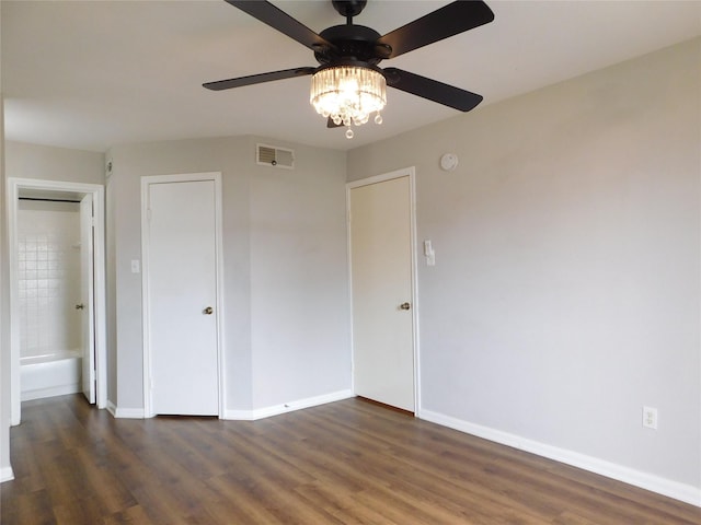 unfurnished bedroom featuring ceiling fan and dark wood-type flooring