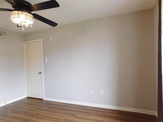 spare room featuring ceiling fan and dark hardwood / wood-style floors