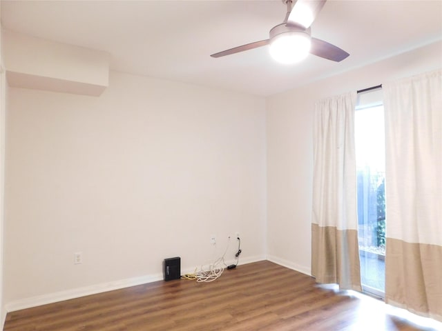 spare room featuring ceiling fan and dark hardwood / wood-style flooring