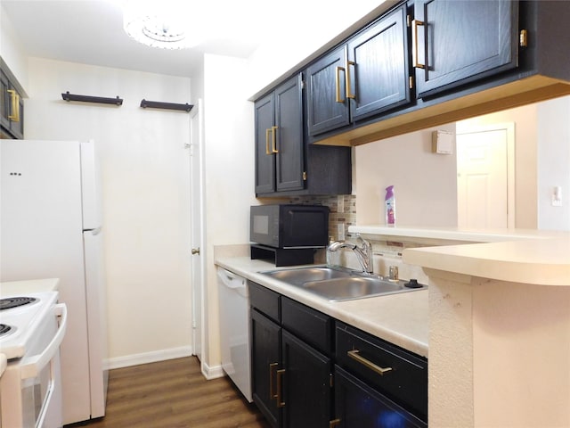 kitchen with dark hardwood / wood-style flooring, white appliances, and sink