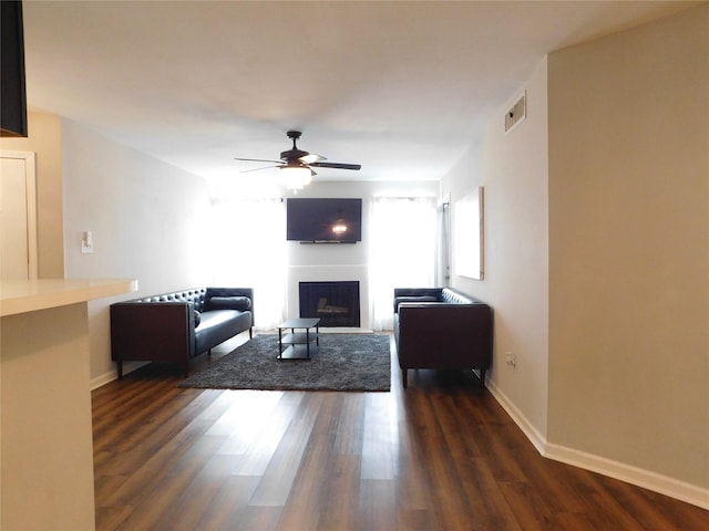 living room featuring dark hardwood / wood-style floors and ceiling fan