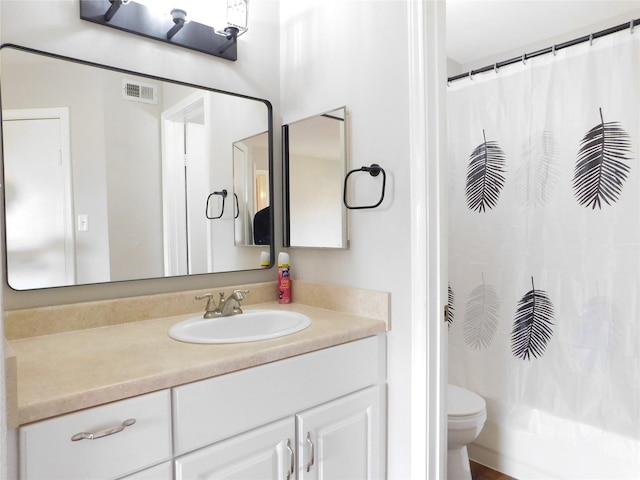 full bathroom featuring vanity, toilet, and shower / tub combo