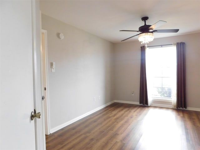 spare room featuring ceiling fan and dark wood-type flooring