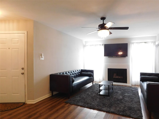 living room with ceiling fan and dark hardwood / wood-style floors