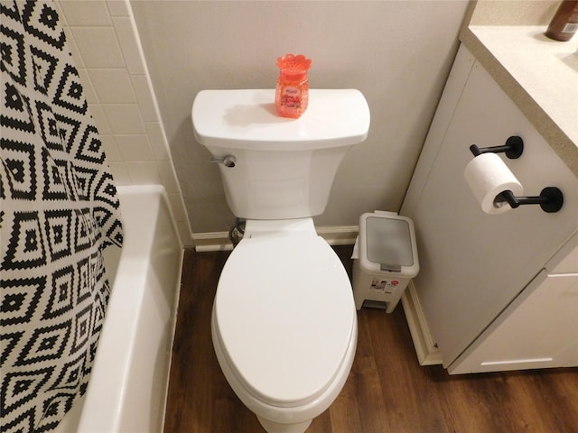 bathroom featuring plus walk in shower, wood-type flooring, and toilet