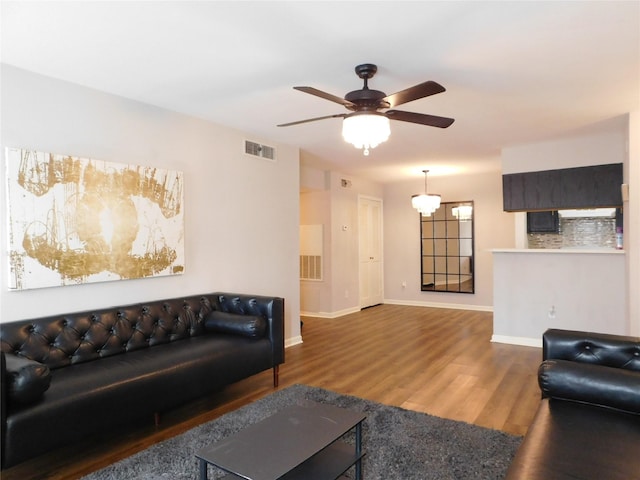 living room with wood-type flooring and ceiling fan