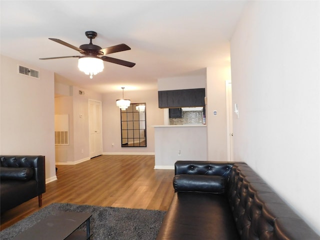 living room featuring ceiling fan and hardwood / wood-style floors