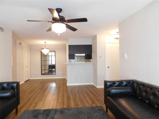 living room with ceiling fan and dark hardwood / wood-style flooring