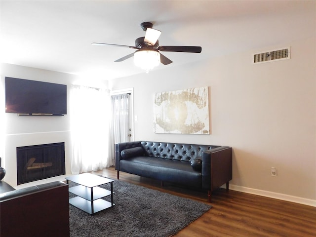 living room with dark hardwood / wood-style floors and ceiling fan