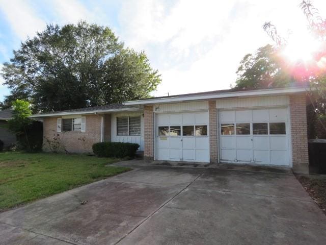 view of front of home with a front lawn and a garage