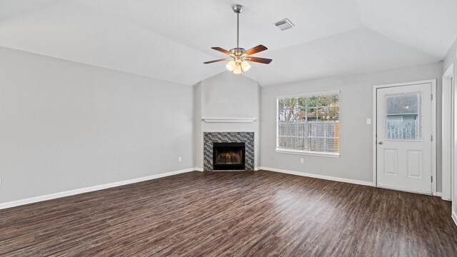 unfurnished living room with dark hardwood / wood-style floors, ceiling fan, a tile fireplace, and vaulted ceiling