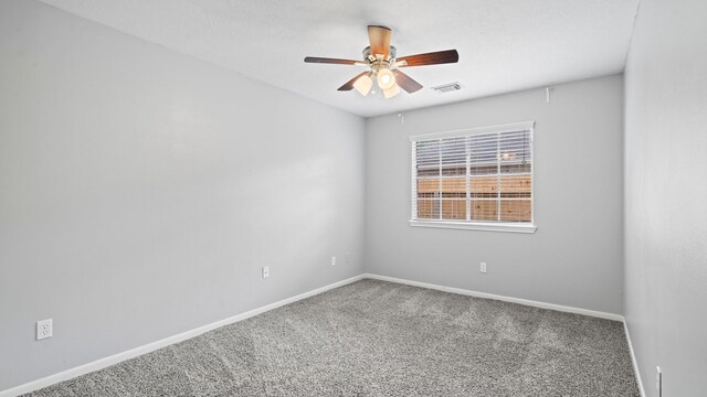 empty room with ceiling fan and carpet floors