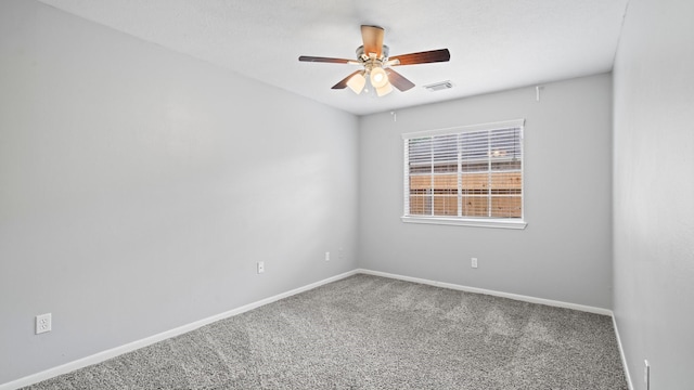 spare room featuring ceiling fan and carpet flooring