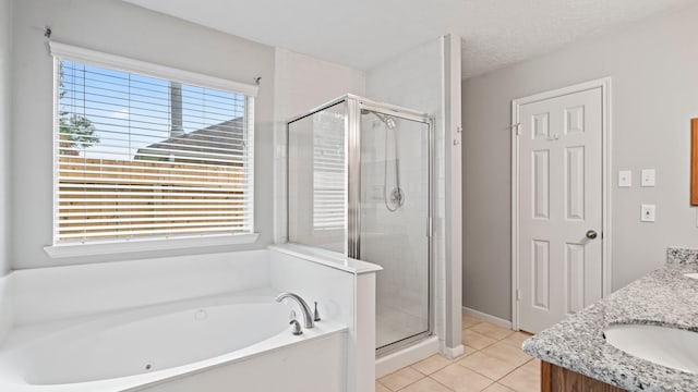 bathroom featuring plenty of natural light, independent shower and bath, and a textured ceiling