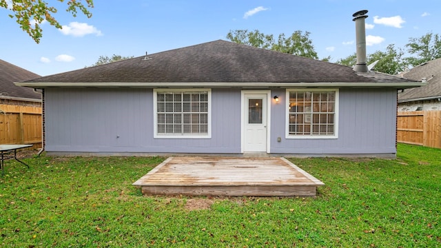 back of house with a lawn and a wooden deck