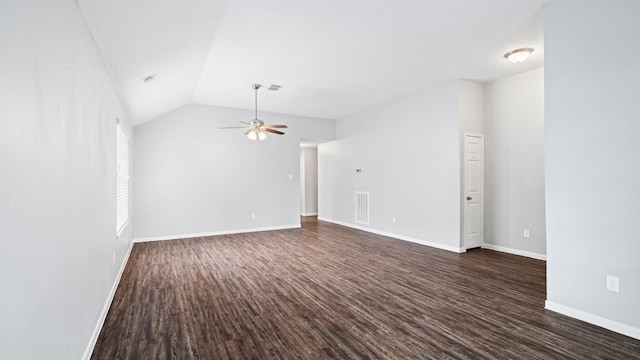 empty room featuring ceiling fan, dark wood-type flooring, and vaulted ceiling