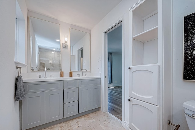 bathroom with vanity, hardwood / wood-style flooring, toilet, and walk in shower