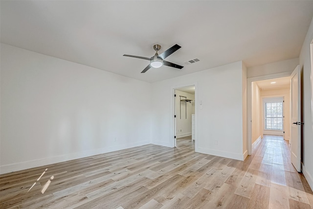 spare room with ceiling fan and light wood-type flooring