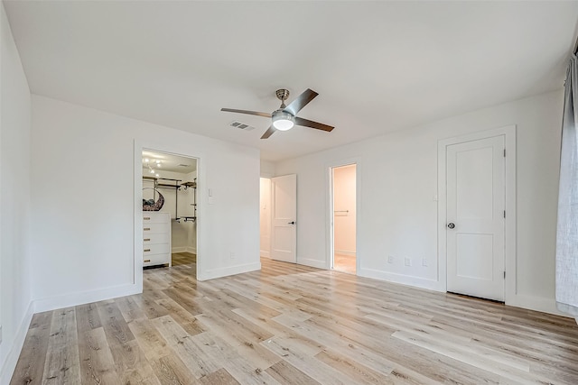 unfurnished bedroom featuring ensuite bathroom, light hardwood / wood-style flooring, and ceiling fan