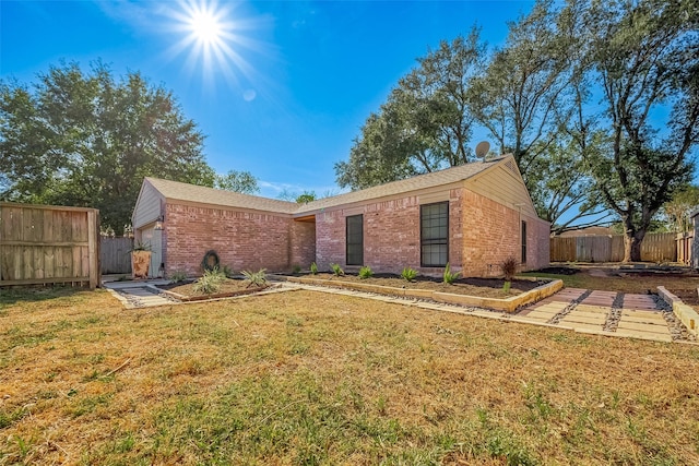 ranch-style home with a front yard and a garage