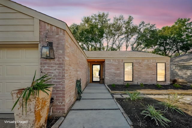 view of exterior entry at dusk