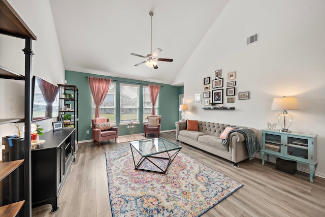 living room featuring ceiling fan, high vaulted ceiling, and hardwood / wood-style flooring