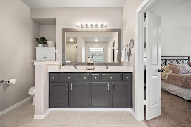 bathroom featuring tile patterned flooring, vanity, toilet, and walk in shower