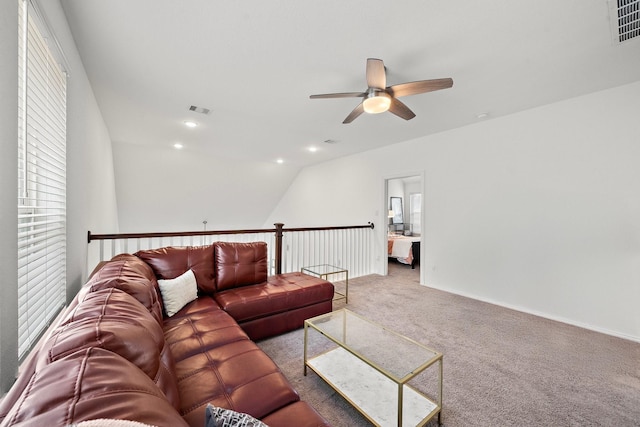 carpeted living room featuring ceiling fan and vaulted ceiling