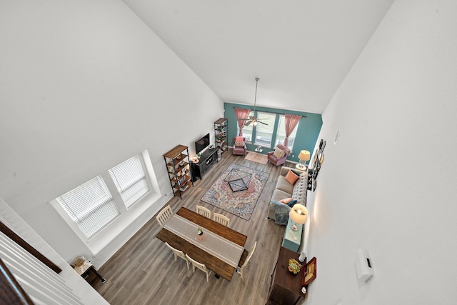 living room with ceiling fan, high vaulted ceiling, and hardwood / wood-style flooring