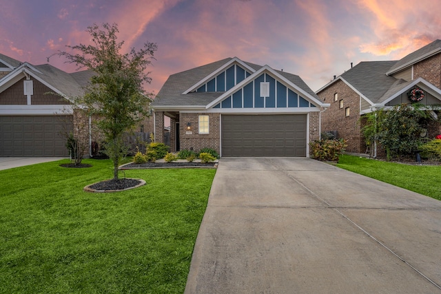 craftsman inspired home with a yard and a garage